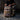 45L Khaki American Flag Backpack with Cup Holders resting on gravel with a person holding the zipper.