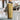 Gold 26 oz Stainless Steel Shaker Bottle sitting on a bench inside the gym.